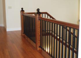 Custom railing featuring both wood and wrought iron and custom iron newel post. Custom railing featuring both wood and wrought iron and custom iron newel post.