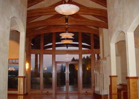 Vaulted beam ceiling with dropped arched glue lam beams clear finish.