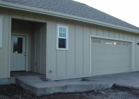 Concrete wheel ramp from driveway to covered house entrance. Concrete wheel ramp from driveway to covered house entrance.