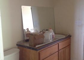 No paint, trim, counter top attached, sink hook up, mirror, damaged sub floor.
