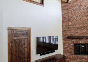 Floor-ceiling brick fireplace with unique mantle Floor-ceiling brick fireplace with unique mantle