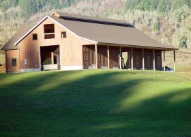 Even the grass looks perfect for this facility! Outside Barn Equestrian Facility